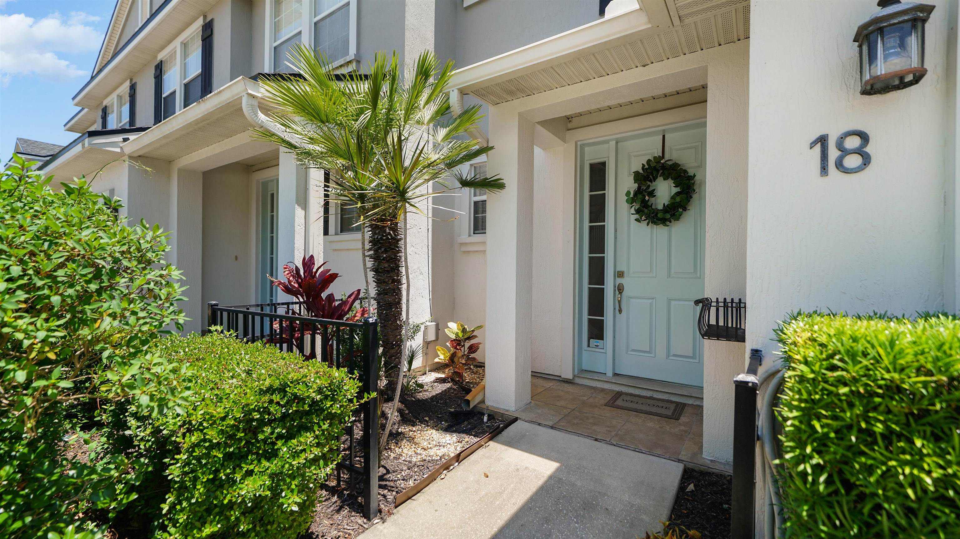 18 Amistad Drive, Unit 18 St. Augustine, FL 32086 - Photo 2 of 36 a view of a house with a flower garden
