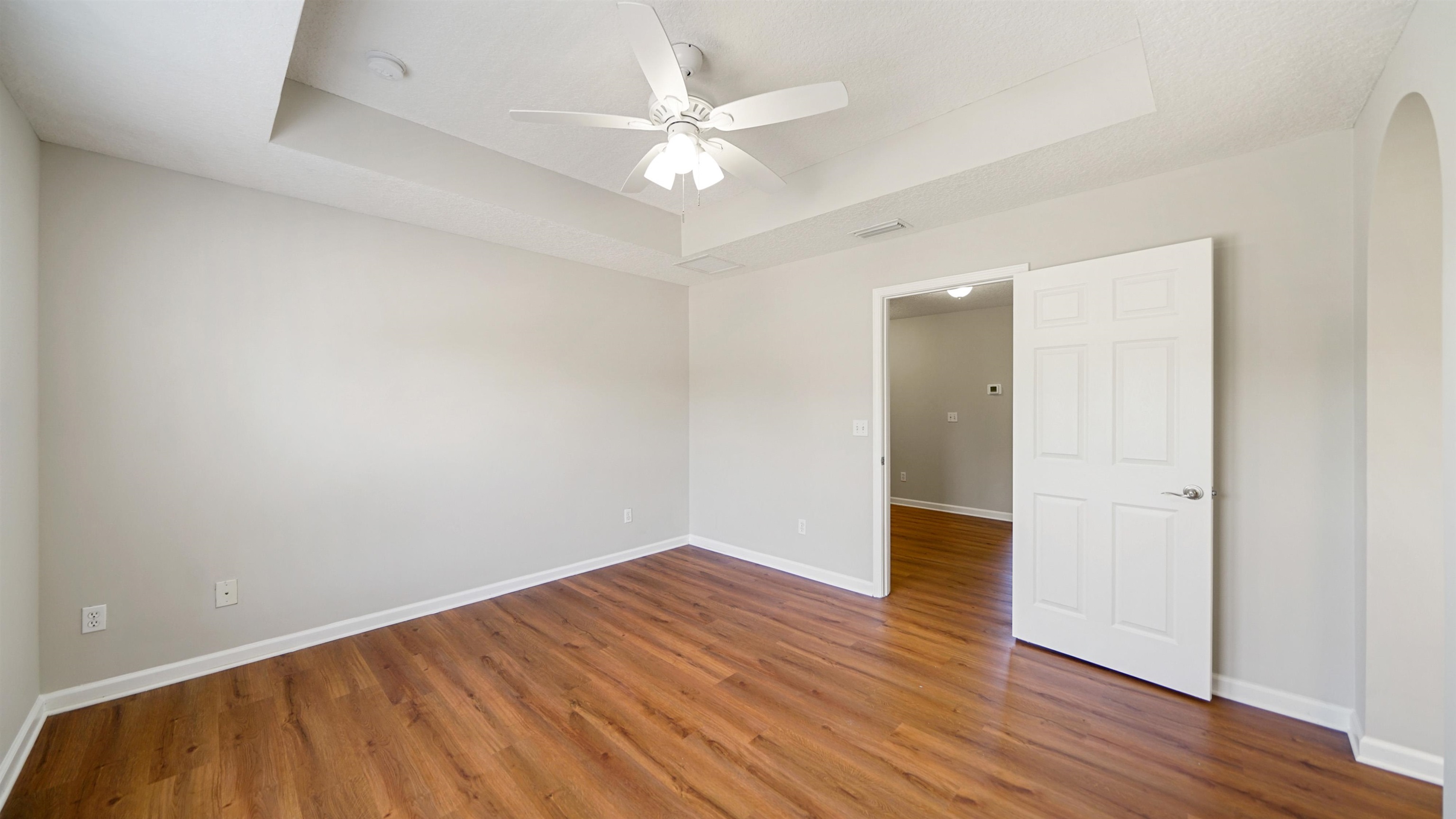 18 Amistad Drive, Unit 18 St. Augustine, FL 32086 - Photo 22 of 36 an empty room with wooden floor and fan