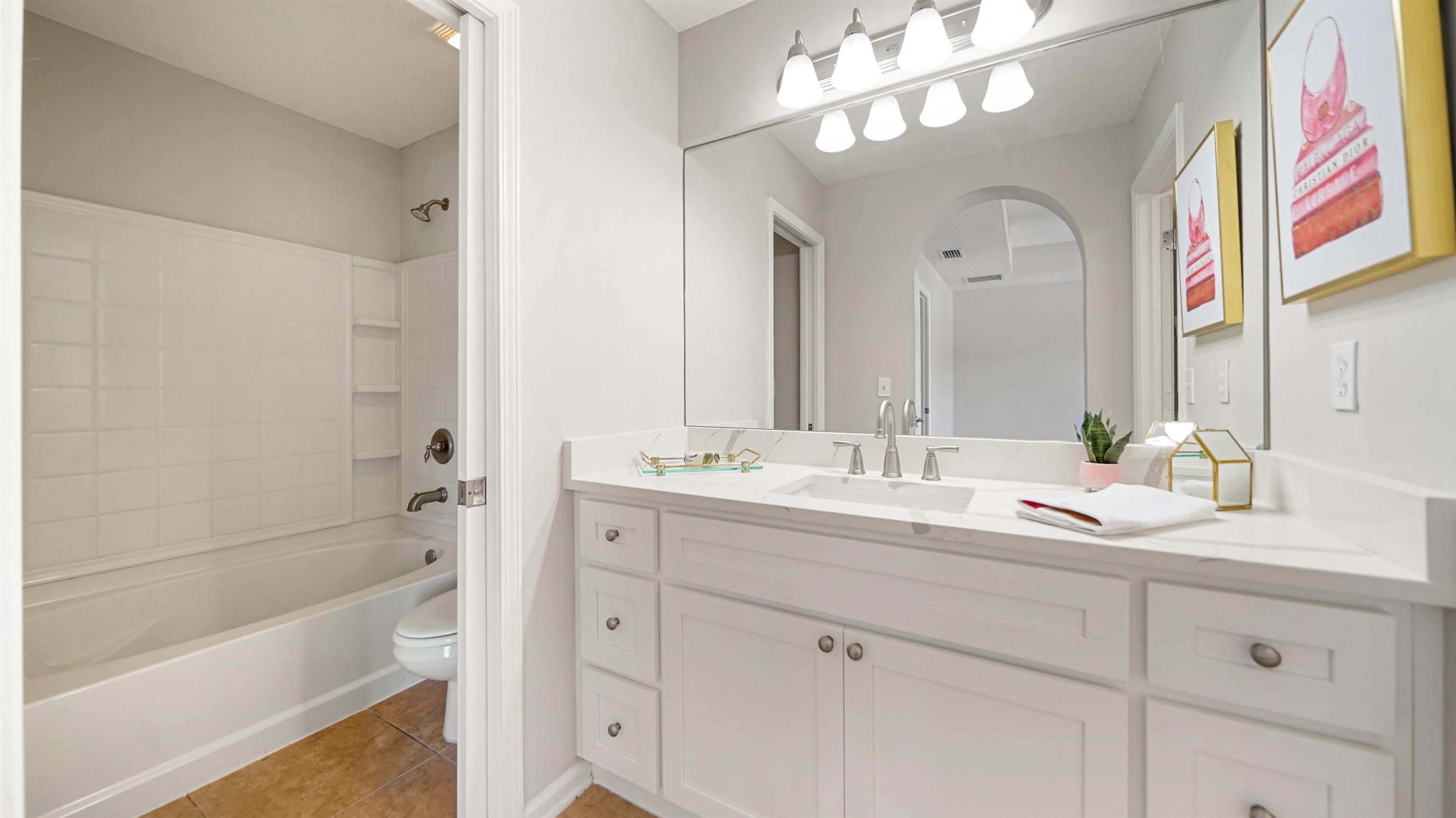 18 Amistad Drive, Unit 18 St. Augustine, FL 32086 - Photo 23 of 36 a bathroom with a sink a large mirror and a bathtub