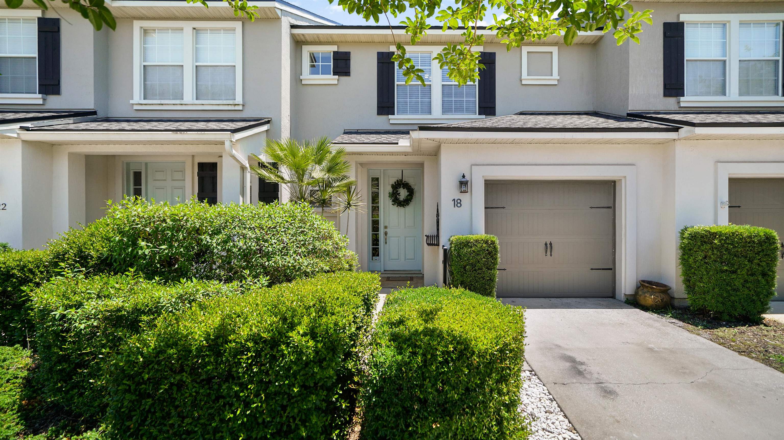 18 Amistad Drive, Unit 18 St. Augustine, FL 32086 - Photo 32 of 36 a front view of a house with garden