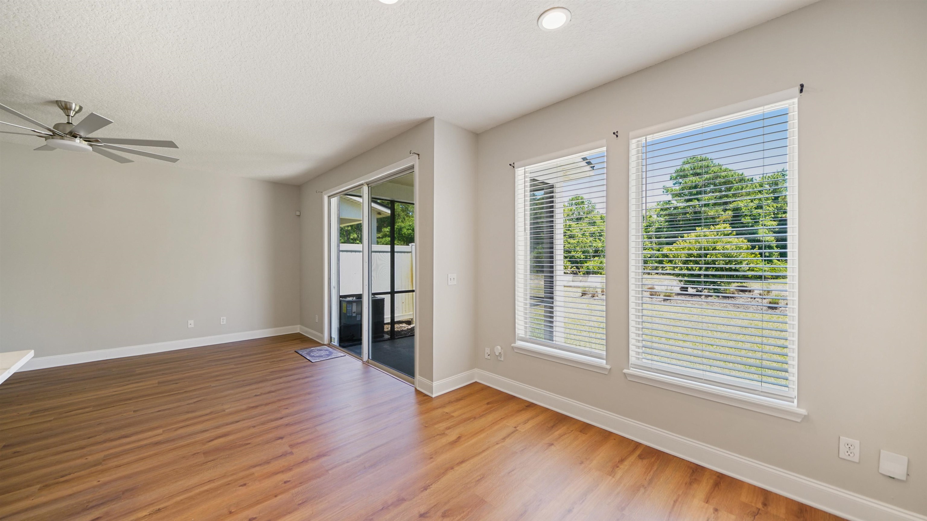 18 Amistad Drive, Unit 18 St. Augustine, FL 32086 - Photo 9 of 36 a view of an empty room with wooden floor and a window