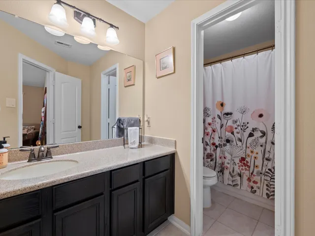 an aerial view of a house with a garden and lake view