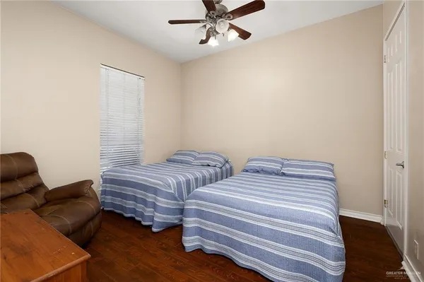 a bedroom with two beds and a chandelier