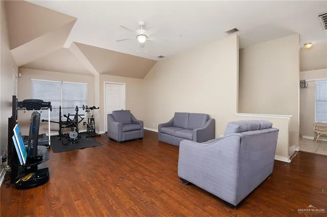 a living room with furniture a flat screen tv and a window