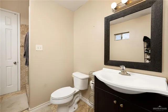 a bathroom with a sink a toilet and mirror