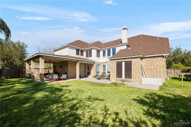 a front view of a house with a yard table and chairs