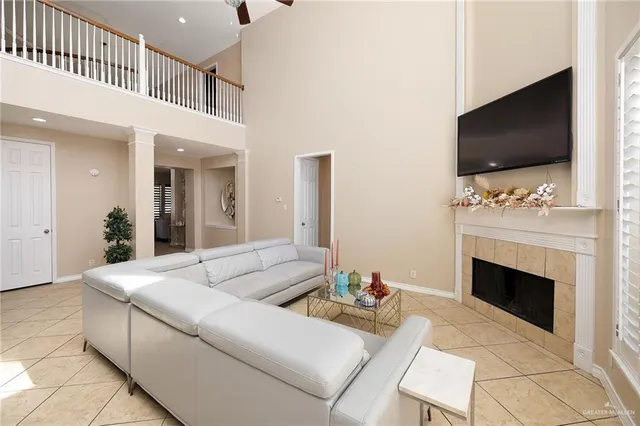 a living room with furniture a flat screen tv and a fireplace