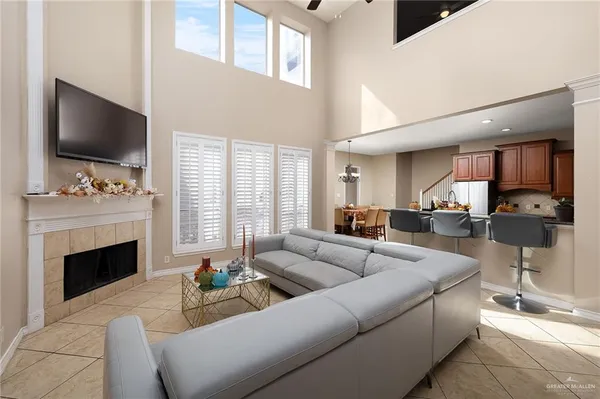 a living room with furniture a flat screen tv and a fireplace