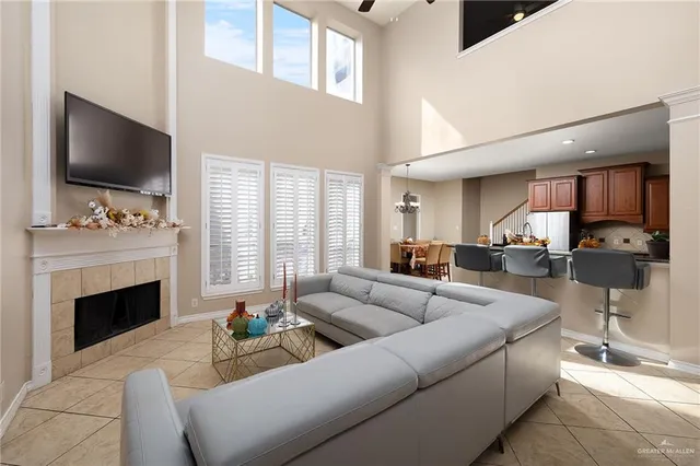 a living room with furniture a flat screen tv and a fireplace