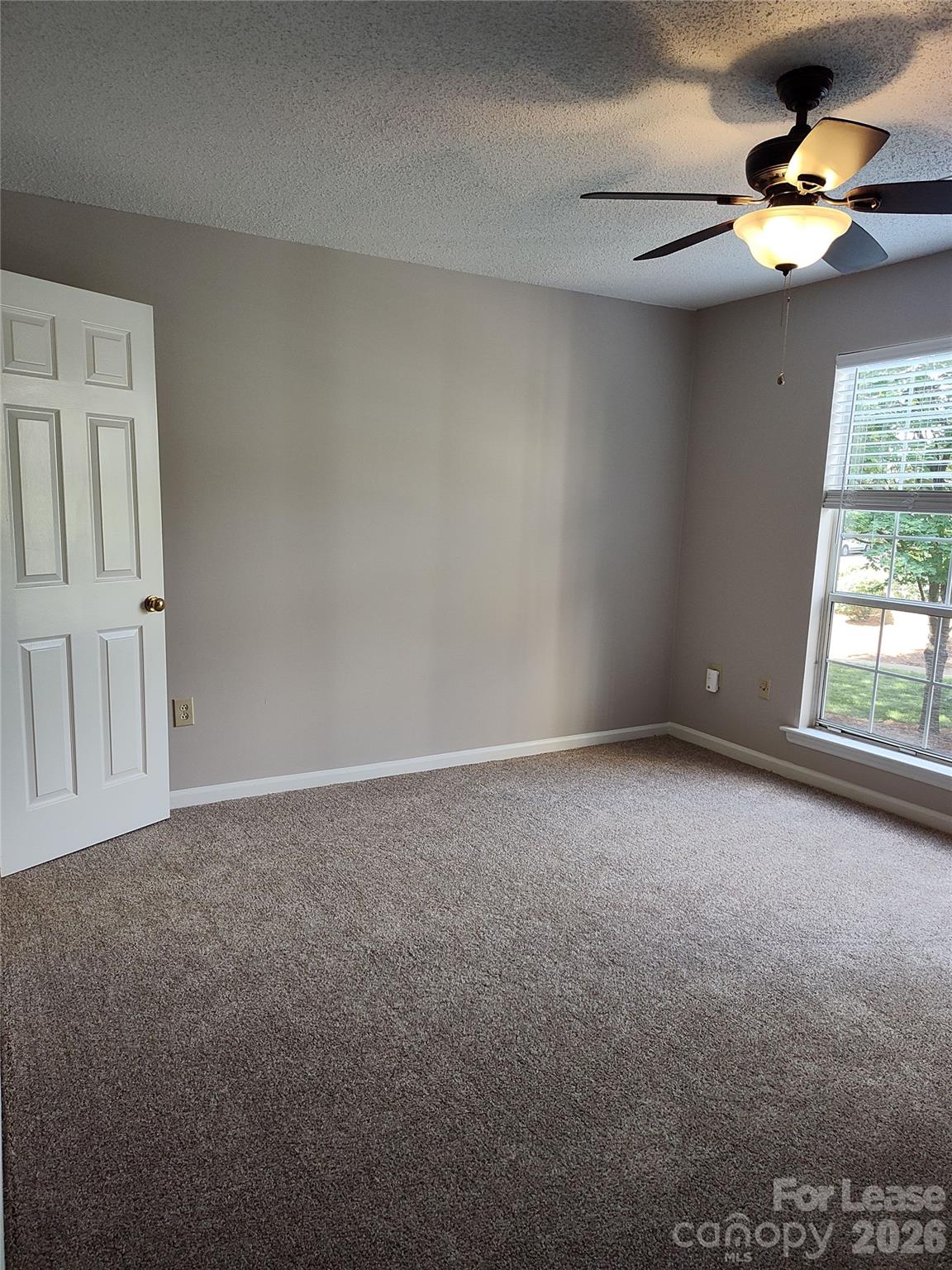 5001 Sharon Road, Unit K Charlotte, NC 28210 - Photo 20 of 24 a view of an empty room with a window
