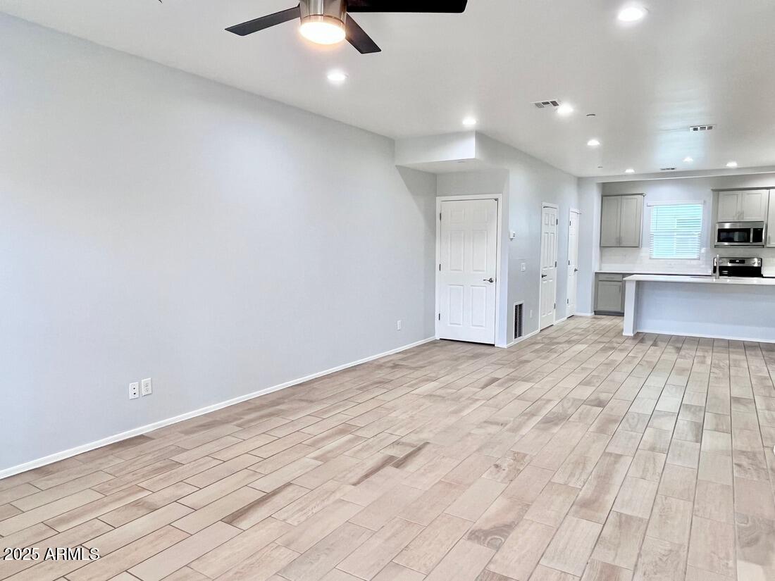 3434 North Longview Avenue, Unit 13 Phoenix, AZ 85014 - Photo 15 of 53 wooden floor in an empty room with a kitchen