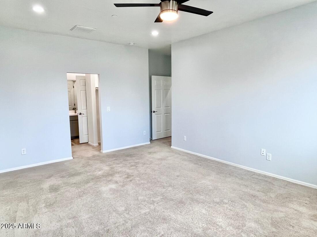 3434 North Longview Avenue, Unit 13 Phoenix, AZ 85014 - Photo 20 of 53 an empty room with a ceiling fan and window