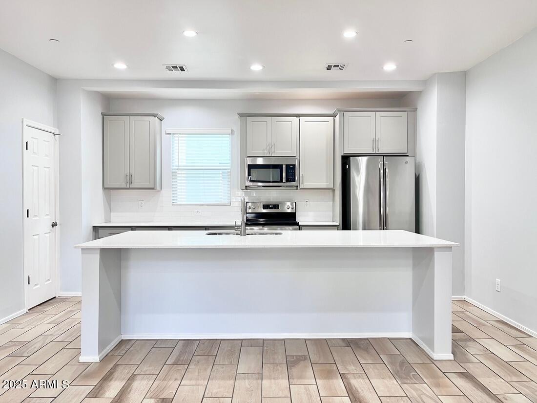 3434 North Longview Avenue, Unit 13 Phoenix, AZ 85014 - Photo 2 of 53 a kitchen with stainless steel appliances a refrigerator and a stove top oven