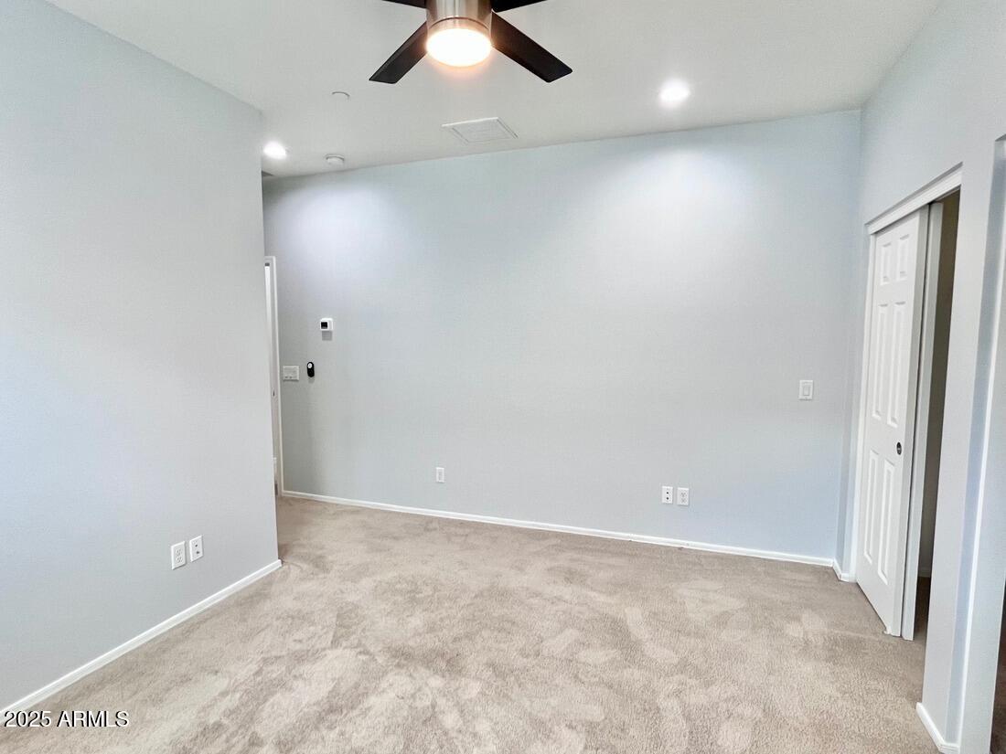 3434 North Longview Avenue, Unit 13 Phoenix, AZ 85014 - Photo 33 of 53 an empty room with fan and windows