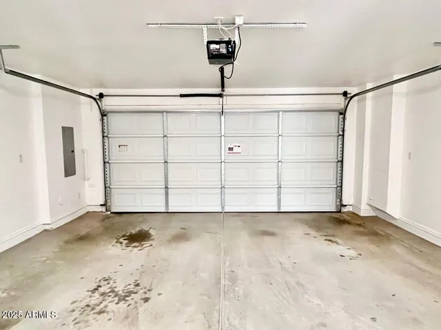 a view of a hallway with wooden floor and a living room