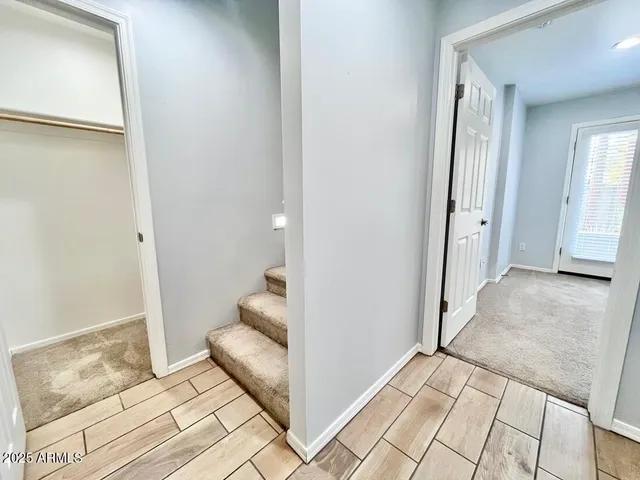 an empty room with closet and a ceiling fan