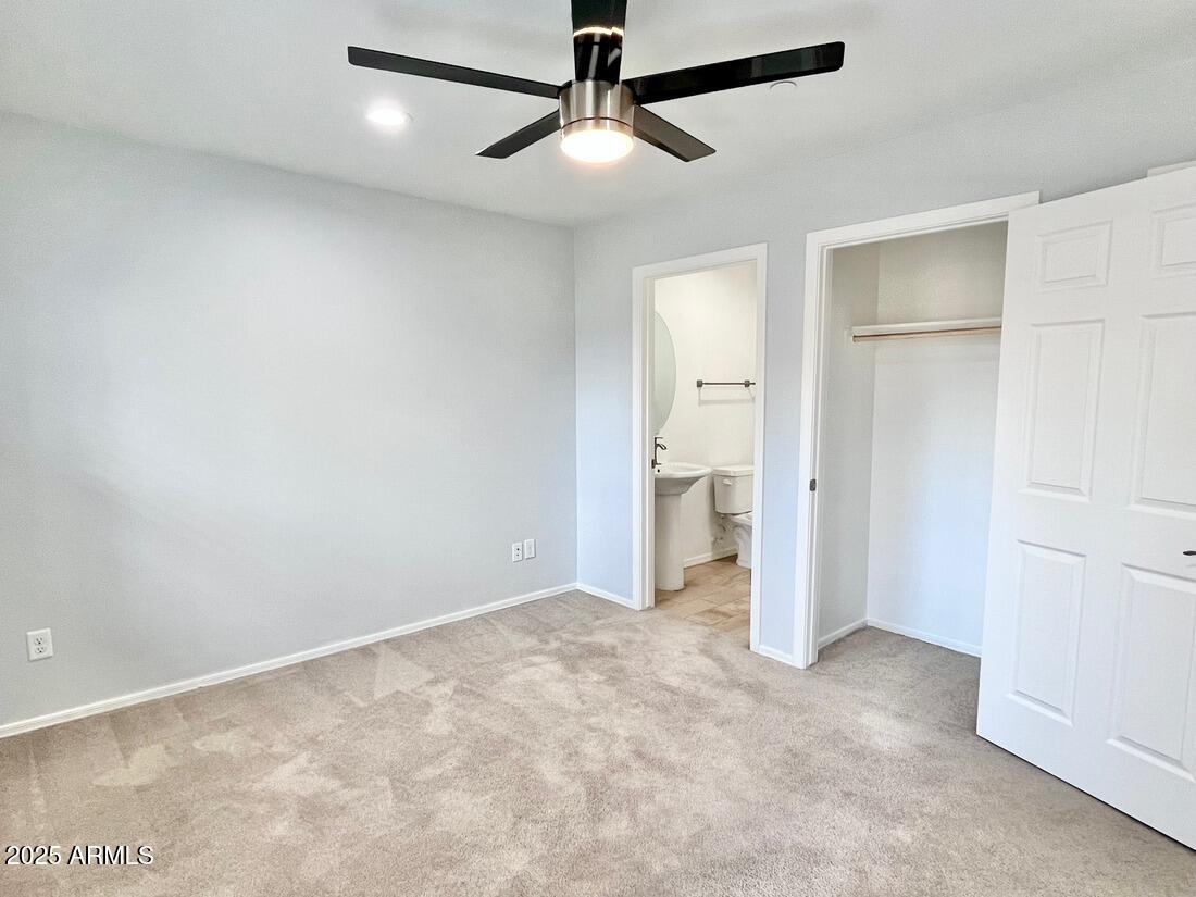 3434 North Longview Avenue, Unit 13 Phoenix, AZ 85014 - Photo 39 of 53 an empty room with closet and a ceiling fan