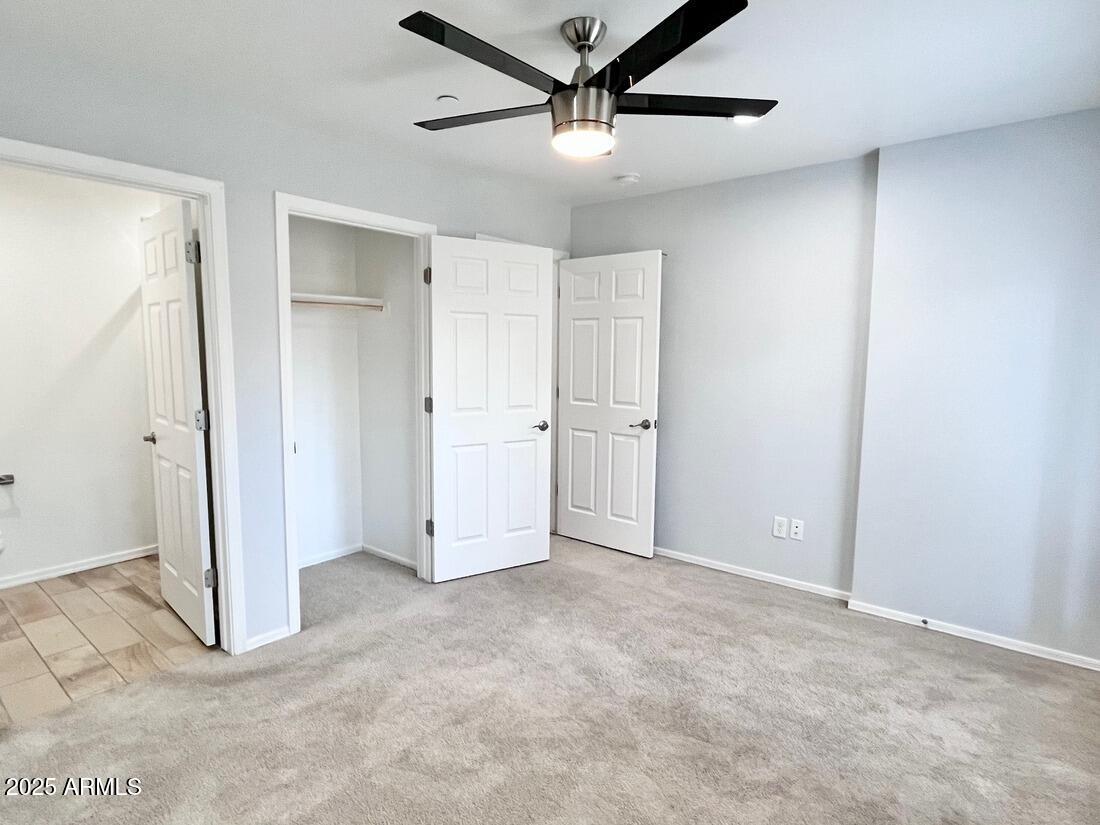 3434 North Longview Avenue, Unit 13 Phoenix, AZ 85014 - Photo 40 of 53 an empty room with closet and a ceiling fan