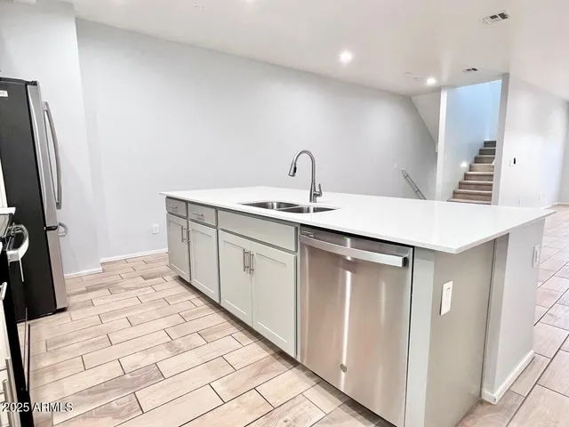 a kitchen with a sink and a refrigerator