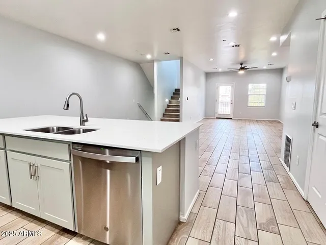 a kitchen with kitchen island a sink stainless steel appliances and cabinets