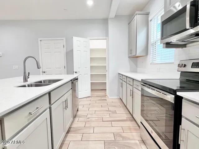 a kitchen with a sink stove and cabinets
