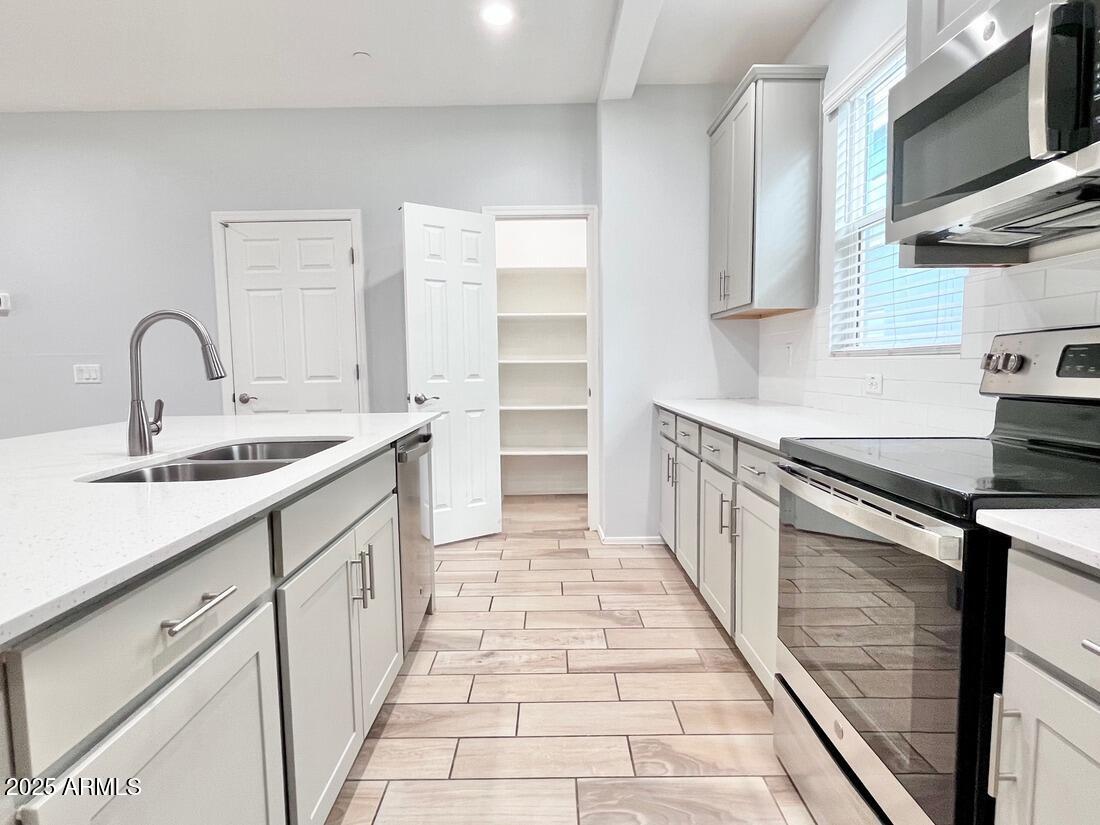 3434 North Longview Avenue, Unit 13 Phoenix, AZ 85014 - Photo 9 of 53 a kitchen with a sink stove and cabinets