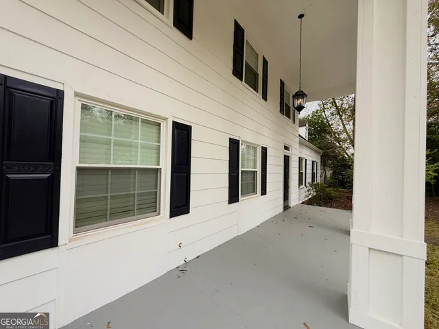 an empty room with wooden floor and closet