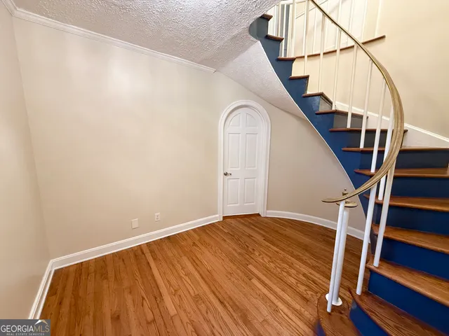 an empty room with wooden floor and fireplace