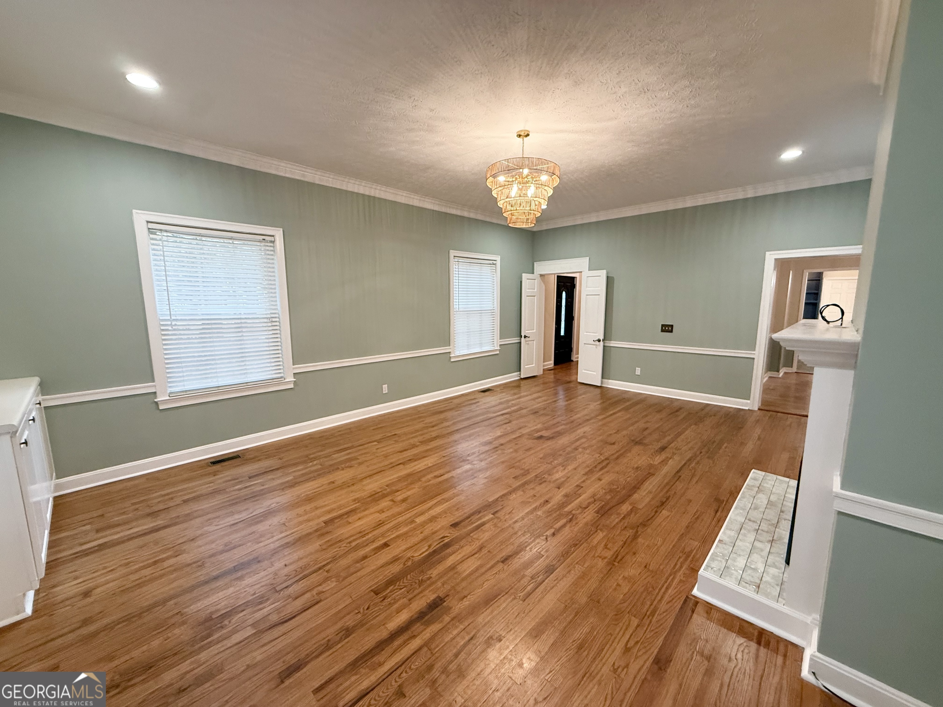 209 Mimosa Drive Dublin, GA 31021 - Photo 29 of 68 wooden floor in an empty room with a window