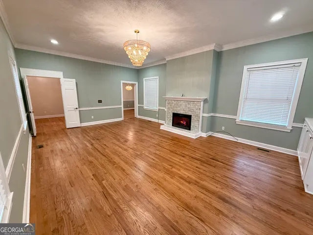 a kitchen with granite countertop white cabinets and stainless steel appliances