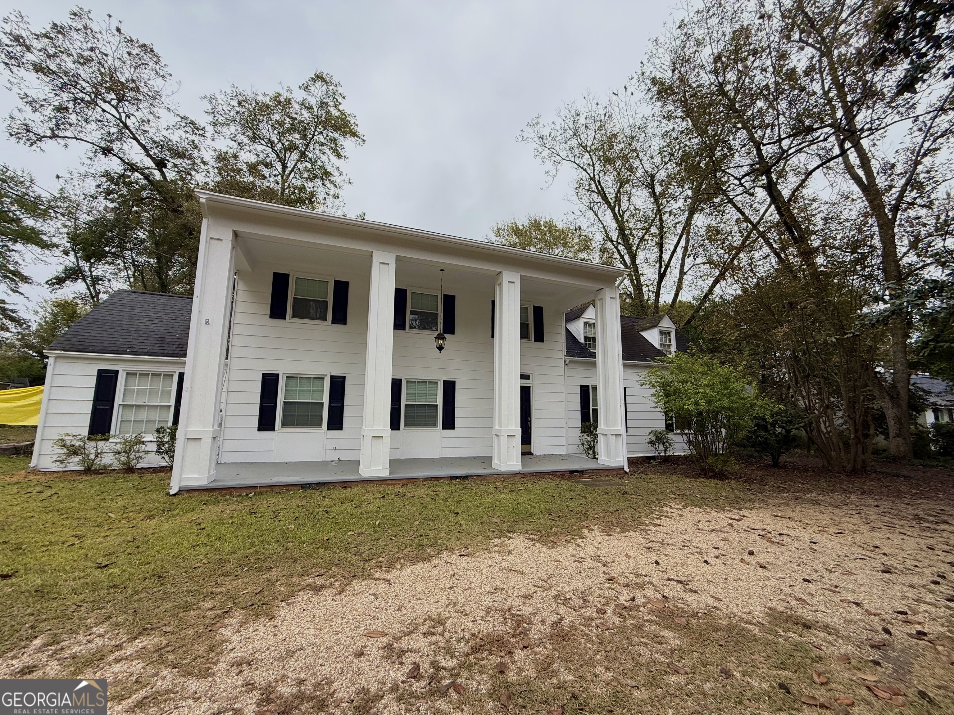 209 Mimosa Drive Dublin, GA 31021 - Photo 3 of 68 a house that has a tree in front of it
