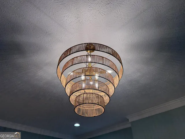 a kitchen with kitchen island granite countertop a sink cabinets and refrigerator