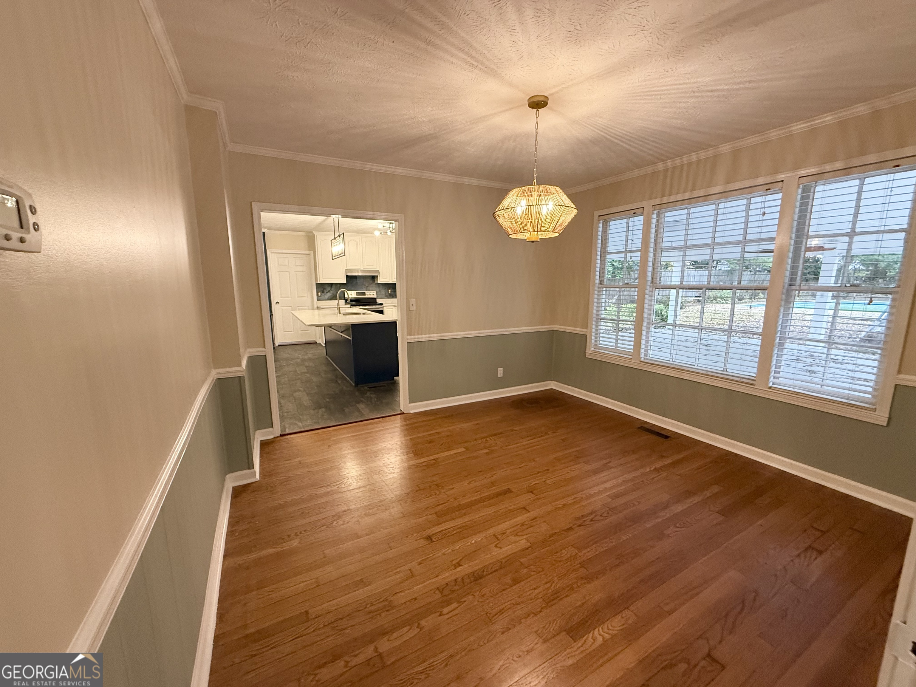 209 Mimosa Drive Dublin, GA 31021 - Photo 33 of 68 an empty room with wooden floor and windows