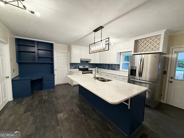 a kitchen with a sink cabinets and wooden floor