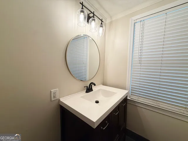 a view of wooden floor and a chandelier fan in a room
