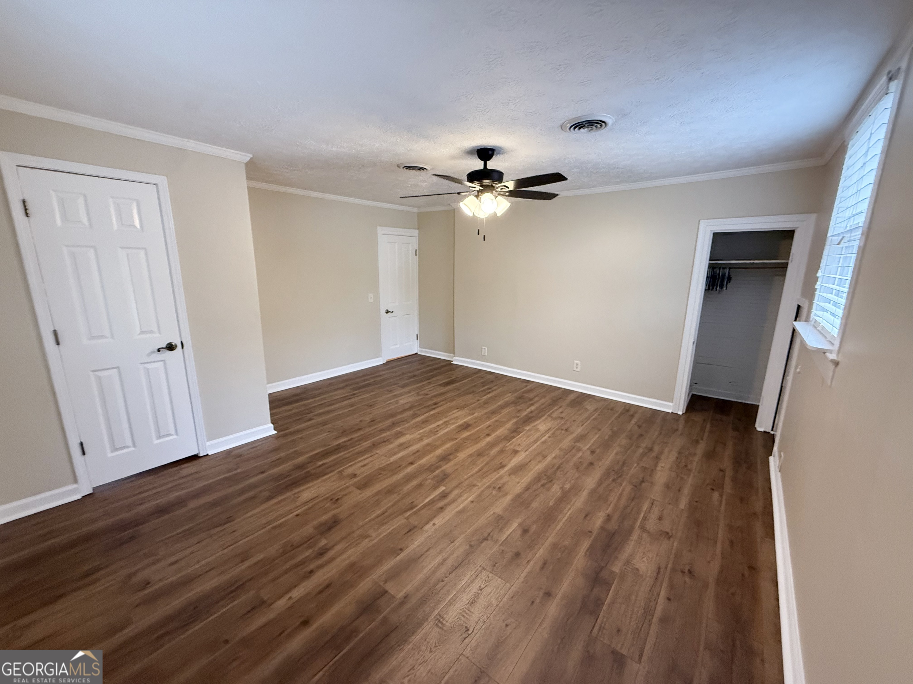 209 Mimosa Drive Dublin, GA 31021 - Photo 64 of 68 wooden floor in an empty room with a window