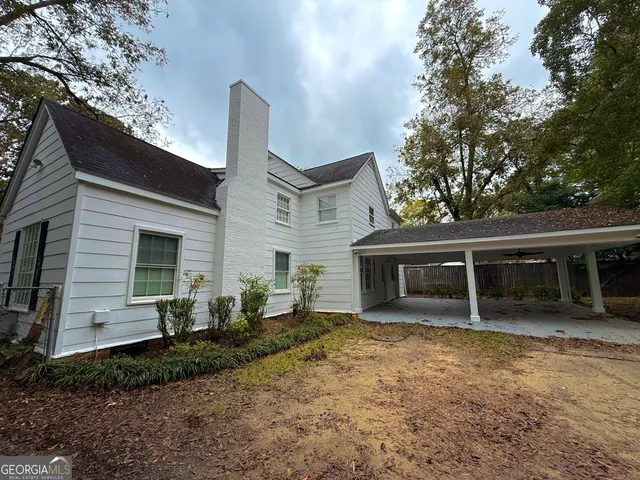 a view of a patio with table and chairs and potted plants