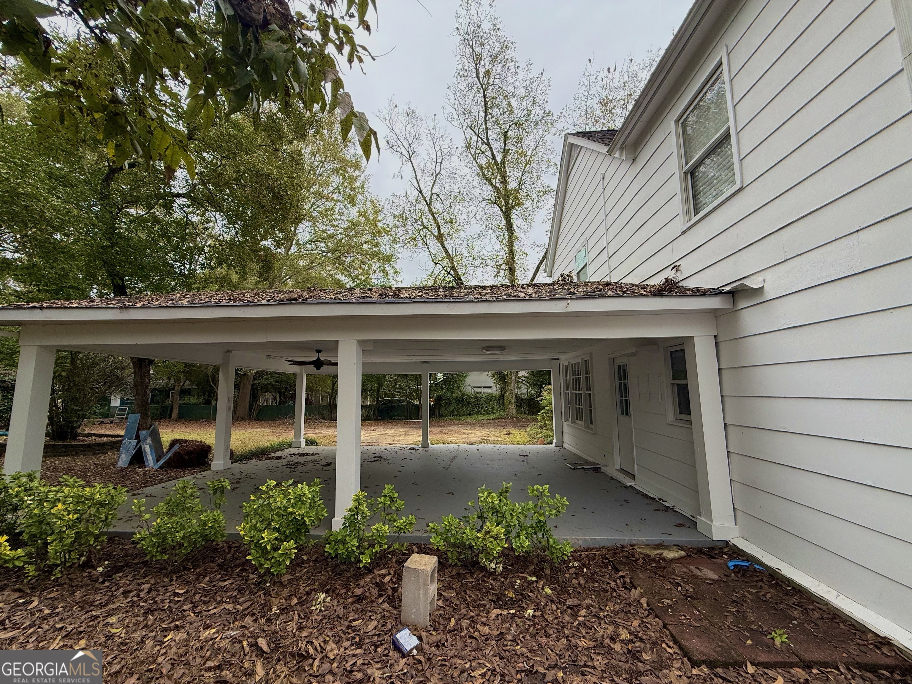 209 Mimosa Drive Dublin, GA 31021 - Photo 10 of 68 a view of a patio with table and chairs and potted plants