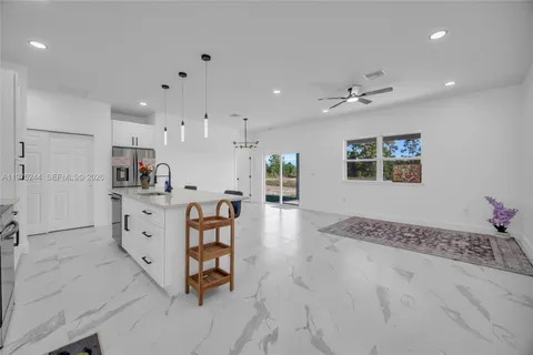 a large white kitchen with white cabinets
