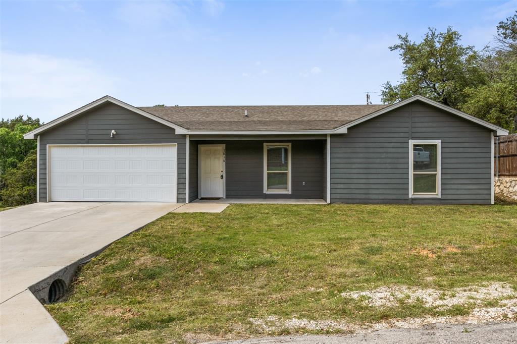 1816 Hidden Valley Road Granbury, TX 76049 - Photo 1 of 23 a front view of a house with a garden