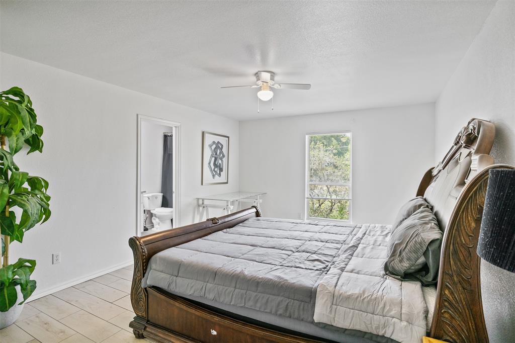 1816 Hidden Valley Road Granbury, TX 76049 - Photo 12 of 23 a bedroom with a bed and a chandelier