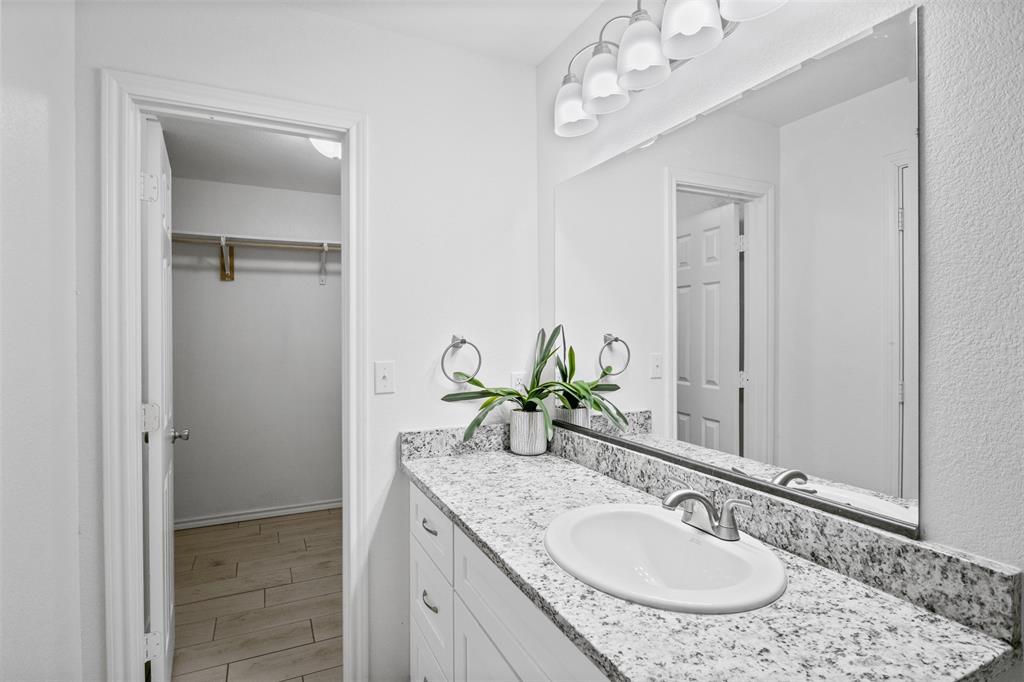 1816 Hidden Valley Road Granbury, TX 76049 - Photo 13 of 23 a bathroom with a granite countertop sink and a mirror