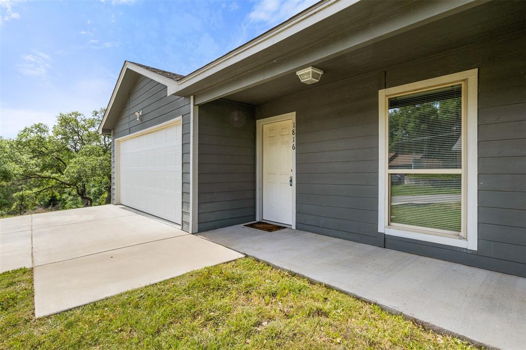 1816 Hidden Valley Road Granbury, TX 76049 - Photo 5 of 23 a view of backyard with large windows