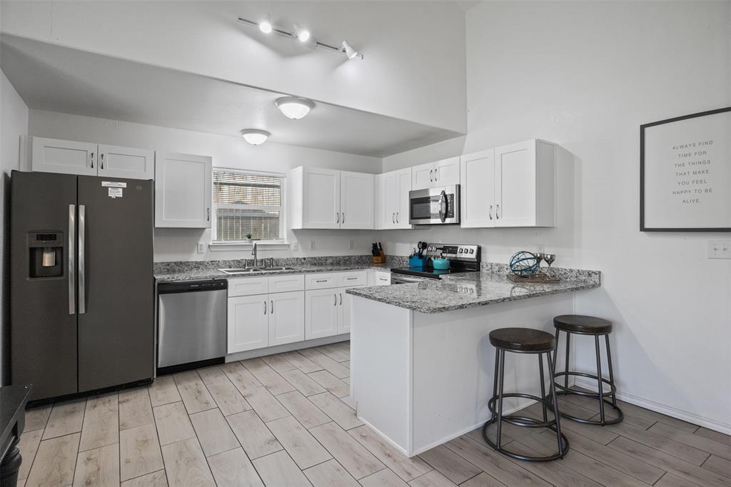1816 Hidden Valley Road Granbury, TX 76049 - Photo 6 of 23 a kitchen with stainless steel appliances granite countertop a refrigerator sink and stove