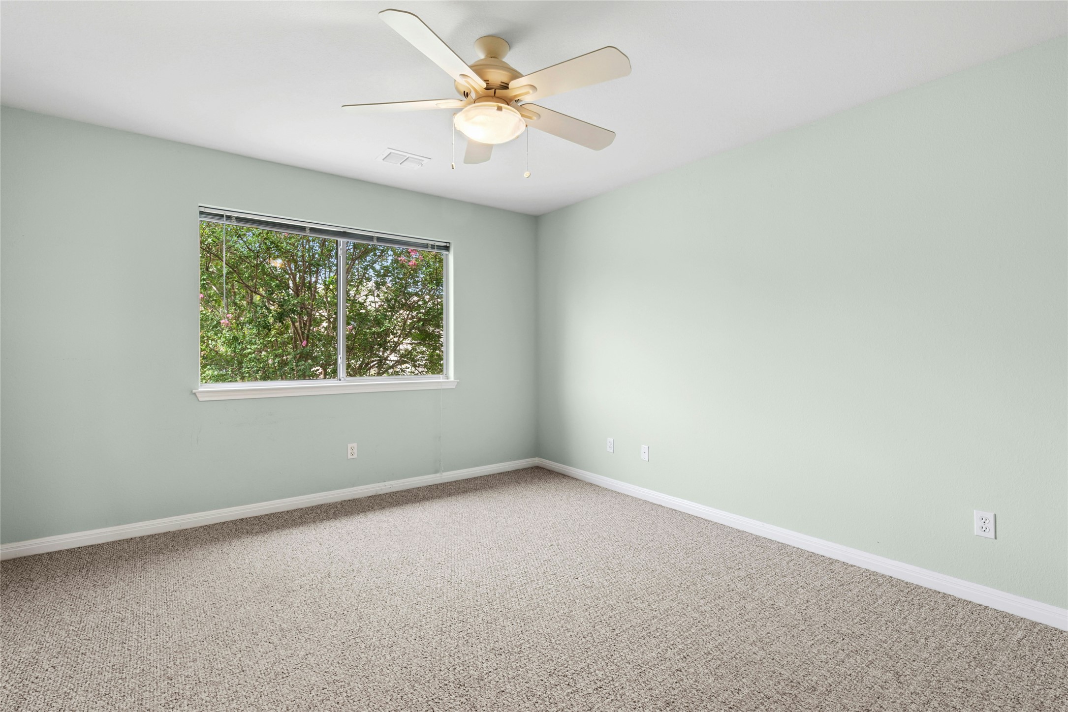 7500 Shadowridge Run, Unit 34 Austin, TX 78749 - Photo 22 of 27 an empty room with a window and a fan