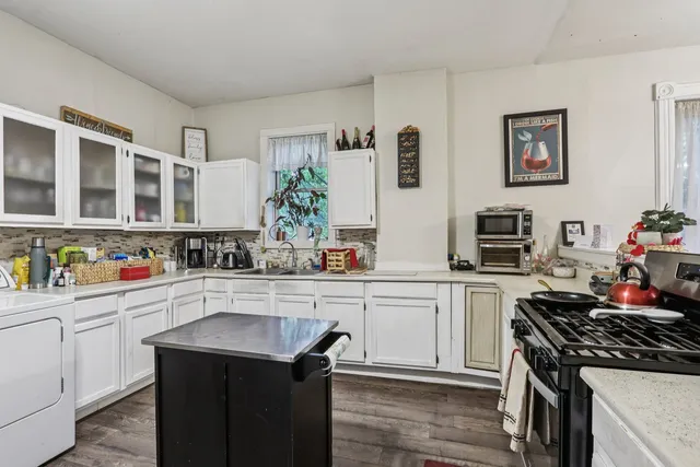 a kitchen with a sink stove and cabinets