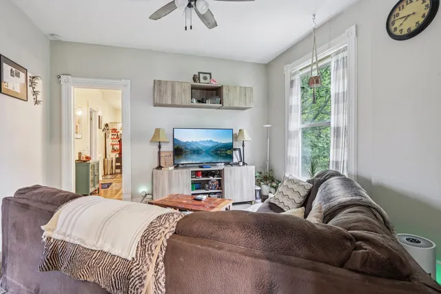 a living room with furniture and a large window