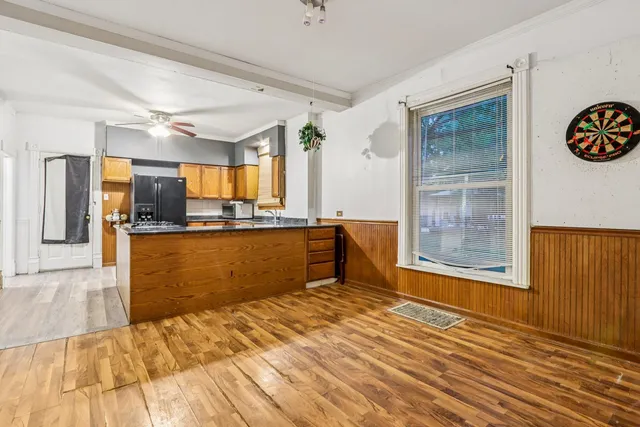 a view of empty room with wooden floor