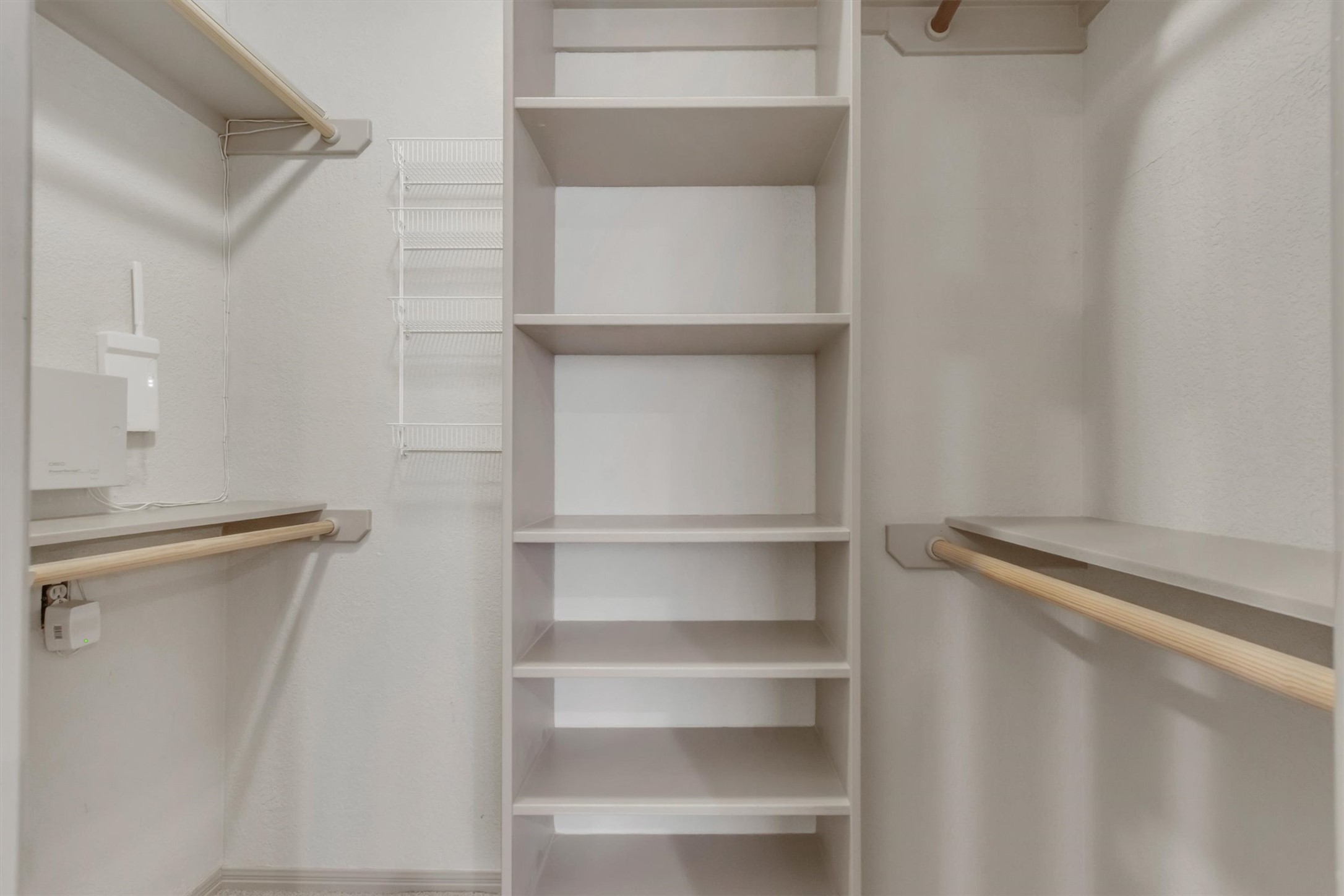 6008 Tributary Ridge Court Austin, TX 78759 - Photo 17 of 36 1 of 2 spacious closets in the primary bedroom, offering ample hanging space and integrated shelving.