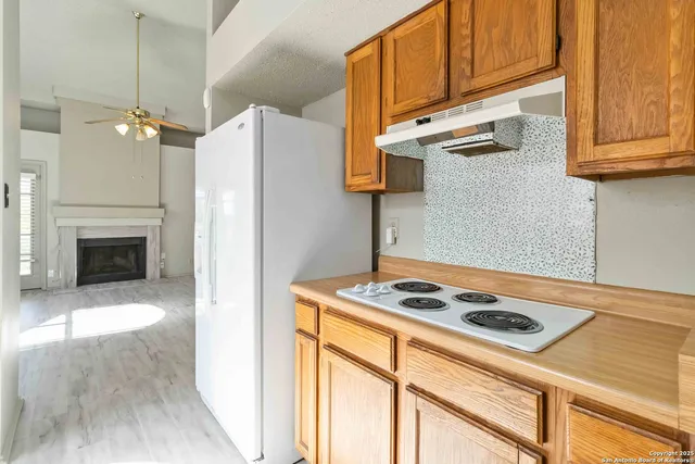 a kitchen with kitchen island a stove cabinets a sink and a counter top space